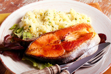Fried salmon and herby couscous aside