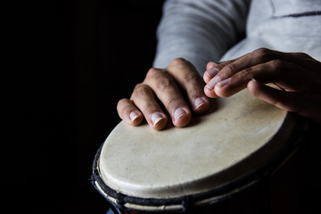 Playing African Drums in Low Key Single Light by Musician in Mus