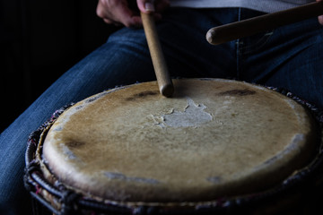 Playing African Drums in Low Key Single Light by Musician in Mus