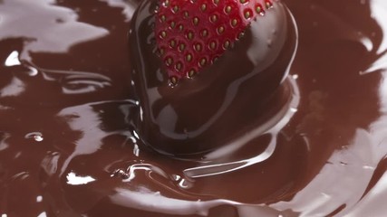 Slow motion of strawberry dipping in melted premium dark chocolate, 180fps prores footage - Powered by Adobe