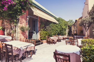 Charming street with cafe tables in the old district of Plaka in Athens, Greece