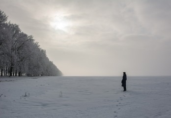 Lonely human in snow covered field