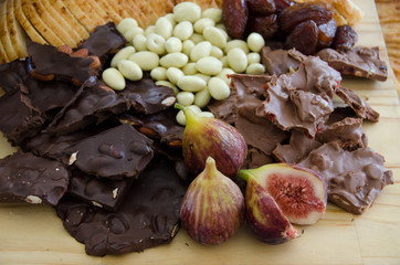 Chocolate chunks and figs on wooden platter