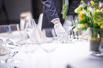 Restaurant personnel preparing the table