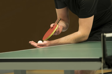 table tennis player serving, closeup
