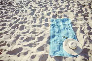 beach background with hat and towel