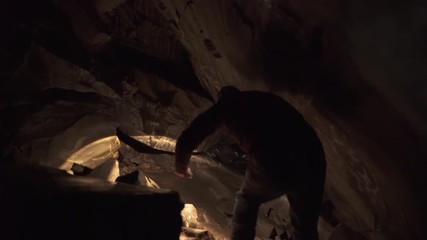 Explorer walking in a cave in Norway
