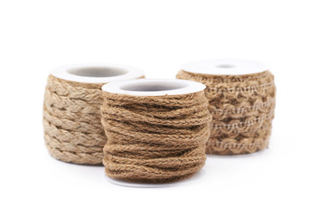 Pile of rope bobbins isolated