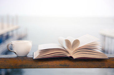 Book and coffee time by the seaside