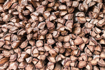 Firewood background - chopped firewood on a stack
