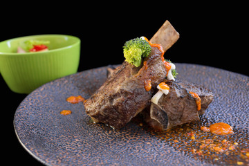 Pork shoulder roasted on black background.