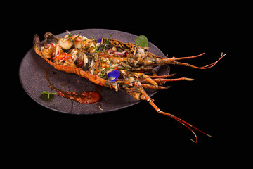 Barbeque lobster dinner on black background