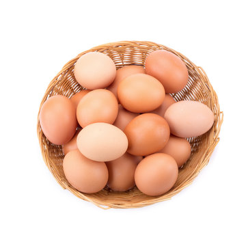 Eggs in basket isolated on white background.