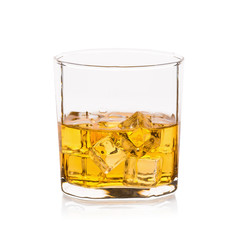 Glass of scotch whiskey and ice on a white background.