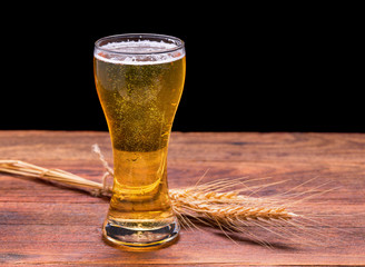 cup of beer on wooden table.
