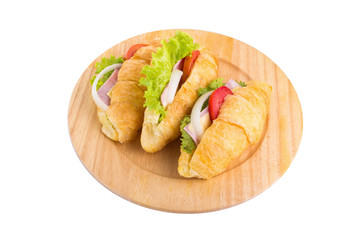 croissant sandwich ham on wooden plate