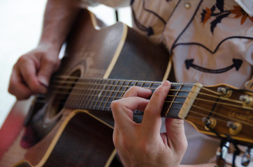 Man playing acoustic guitar at live performance