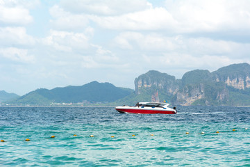 Red speed boat sailing in the sea.