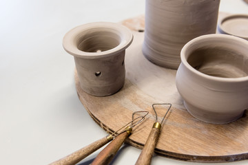 clay pottery appliance on wooden wheel