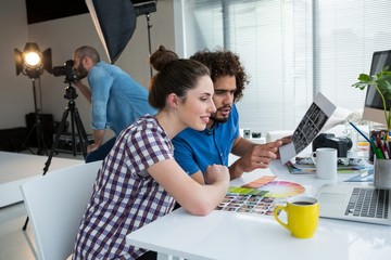 Team of photographers working together at desk