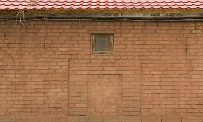 brick wall with roof and small window