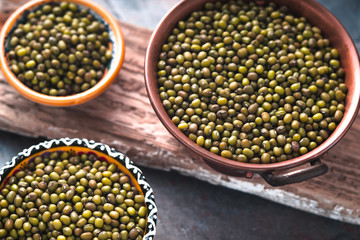 Mung beans in a copper and ceramic bowls on the stand