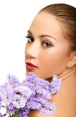 Fototapeta premium Sensual young spa woman holding flower.