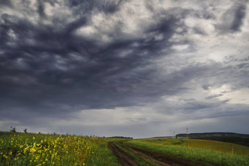 rural landscape with the storm sky and the road