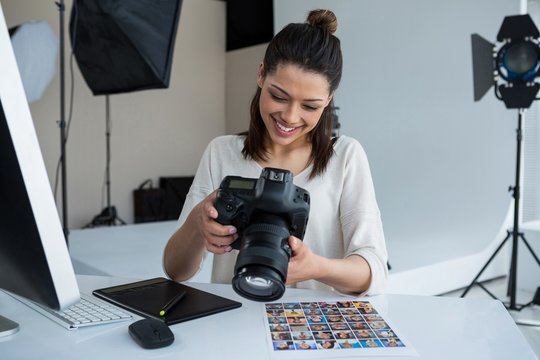 photographer reviewing photos in her camera