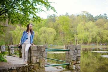 beautiful girl in a dress in the spring in a mask of dry leaf