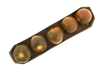 Brown tomatoes in a cardboard container top view isolated on a white background.