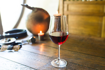 A glass of red wine on the wooden table