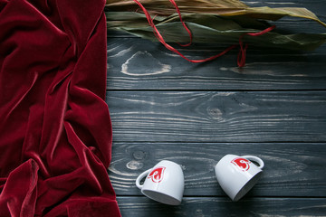 Rustic set of red andvelor two white coffee cups with printed hearts on heart shaped plate and...