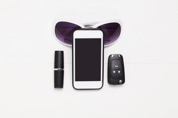Modern accessories for girls. Smart phone, keys, lipstick. Isolated on white background