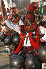Naklejka premium Pernik, Bulgaria - January 28, 2017: Masquerade festival Surva in Pernik, Bulgaria. People with mask called Kukeri dance and perform to scare the evil spirits