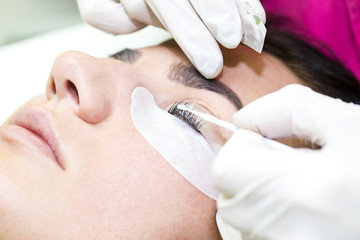 Woman on the procedure for eyelash extensions, eyelashes lamination