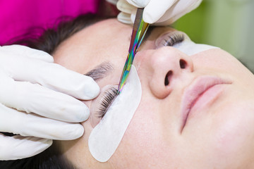 Woman on the procedure for eyelash extensions, eyelashes lamination