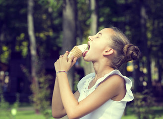 Girl eating ice cream in the park 