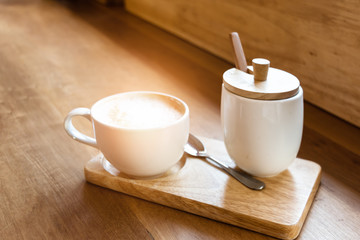 warm vintage concept : hot cappuccino coffee cup in cafe shop