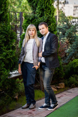 Couple in casual wear posing to camera