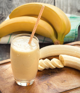 Banana smoothie on a rustic wooden table