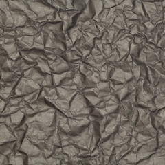 abstract background of crumpled black paper with blotches