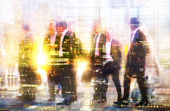 Silhouettes of business people walking in London against of sunset. Multiple exposure image. Business concept illustration.