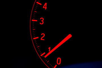 Close up on car speed display in red color with black background