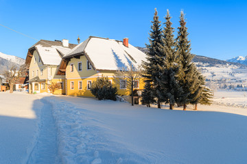 Path in snow to typical guesthouses in Mauterndorf village in winter season, Salzburg Land, Austria