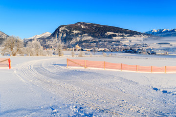 Ski track in Mauterndorf village on early winter morning, Salzburg Land, Austria