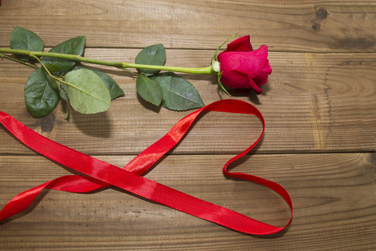 Roses and Ribbon on top of the wood heart shaped