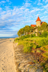 A view of Leba beach and historic hotel building on sand dune, Baltic Sea, Poland