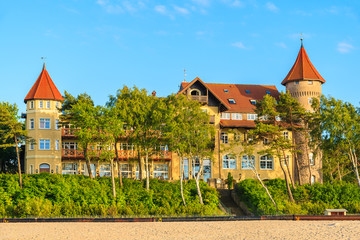 A view of Leba beach and historic hotel building on sand dune, Baltic Sea, Poland © pkazmierczak