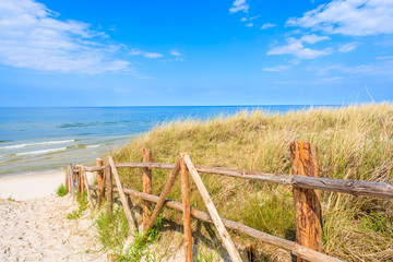 Wooden fence along sand dune on Lubiatowo beach, Baltic Sea, Poland